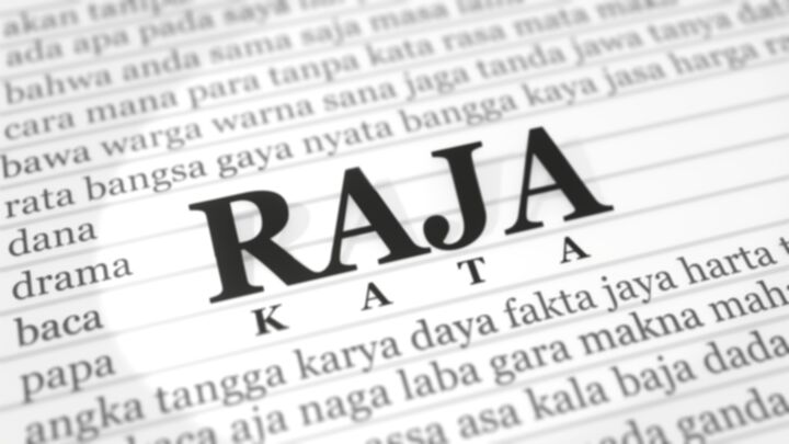 A close up of a paper with the Indonesian word 'Raja' displayed in big bold letters in the center; a smaller word 'Kata' displayed underneath 'Raja'; and dozens of smaller-sized Indonesian words surrounding them that rhymes with the word 'Raja'.